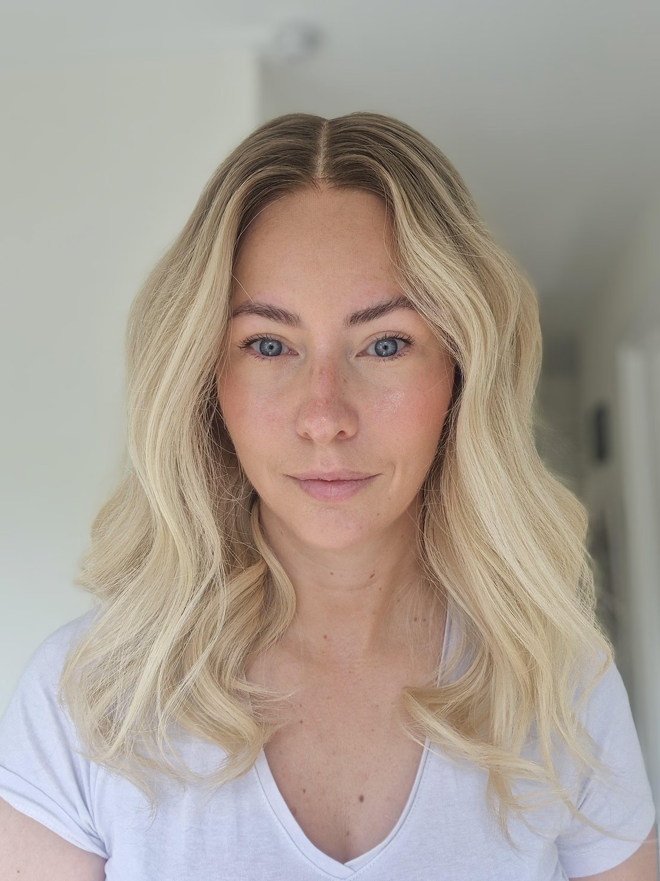 The Mace Wig featuring golden blonde tones and a subtle ash root